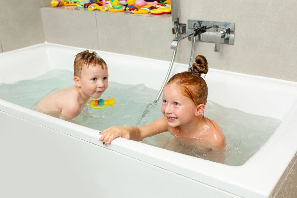 Happy Kids Playing Inside Bathtub